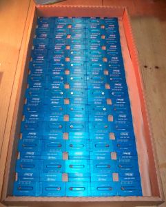 Box of laser marked anodized aluminum measuring units.